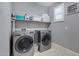 Laundry room with washer, dryer, and built-in shelving at 19538 N Crestview Ln, Maricopa, AZ 85138