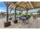 Covered patio area with tables and chairs by pool at 19538 N Crestview Ln, Maricopa, AZ 85138