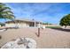 Home's backyard features a covered patio, gravel landscaping, and mature plants at 19607 N Conquistador Dr, Sun City West, AZ 85375