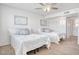 Bright bedroom featuring two beds and a ceiling fan at 19607 N Conquistador Dr, Sun City West, AZ 85375