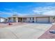 Front view of a single-story house with a driveway and landscaping at 19607 N Conquistador Dr, Sun City West, AZ 85375