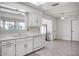 White kitchen with double sink, dishwasher, and ample cabinet space at 19607 N Conquistador Dr, Sun City West, AZ 85375