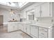 Clean and bright kitchen featuring white cabinets and modern appliances at 19607 N Conquistador Dr, Sun City West, AZ 85375