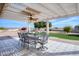 Covered patio with a dining set and ceiling fan at 19607 N Conquistador Dr, Sun City West, AZ 85375