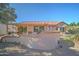 Backyard with covered patio, curved wall, and gravel landscaping at 20055 N Siesta Rock Dr, Surprise, AZ 85374