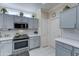 Kitchen with updated grey cabinets and stainless steel appliances at 20055 N Siesta Rock Dr, Surprise, AZ 85374