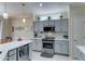 Updated kitchen with stainless steel appliances and white quartz countertops at 20055 N Siesta Rock Dr, Surprise, AZ 85374