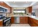 Modern kitchen featuring stainless steel appliances and granite countertops at 2011 E La Jolla Dr, Tempe, AZ 85282