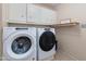 Laundry room with washer, dryer, and storage cabinets at 2011 E La Jolla Dr, Tempe, AZ 85282