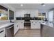 Modern kitchen with white shaker cabinets and stainless steel appliances at 2039 E Aspen Dr, Tempe, AZ 85282