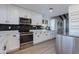 Modern kitchen with white cabinets, stainless steel appliances, and quartz countertops at 2039 E Aspen Dr, Tempe, AZ 85282