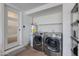 Laundry room with washer, dryer, and shelving at 2039 E Aspen Dr, Tempe, AZ 85282