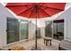 Private patio with red umbrella and small fountain at 2039 E Aspen Dr, Tempe, AZ 85282