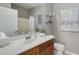 Bathroom with wood vanity, a white sink, and a white toilet at 21320 N 56Th St # 2043, Phoenix, AZ 85054