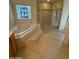 Bathroom with corner tub, walk-in shower, and stained glass window at 2322 S Rogers -- # 9, Mesa, AZ 85202