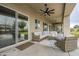 Relaxing patio features wicker furniture and ceiling fan at 24435 S 195Th St, Queen Creek, AZ 85142