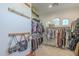 Spacious walk-in closet with custom shelving and hanging rods at 24435 S 195Th St, Queen Creek, AZ 85142