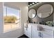 Modern bathroom with double vanity and large mirrors at 2513 N 90Th Ln, Phoenix, AZ 85037