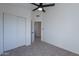 Bright bedroom with ceiling fan and mirrored closet doors at 2513 N 90Th Ln, Phoenix, AZ 85037