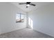 Spacious bedroom with ceiling fan and neutral carpeting at 2513 N 90Th Ln, Phoenix, AZ 85037