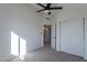 Bedroom with ceiling fan, carpet, and mirrored closet doors at 2513 N 90Th Ln, Phoenix, AZ 85037