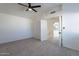 Bedroom with ceiling fan and access to upper level at 2513 N 90Th Ln, Phoenix, AZ 85037