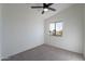 Bright bedroom with ceiling fan and neutral carpeting at 2513 N 90Th Ln, Phoenix, AZ 85037