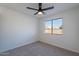 Bright bedroom with ceiling fan and large window at 2513 N 90Th Ln, Phoenix, AZ 85037