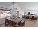 Open concept dining area with a farmhouse table and view into the kitchen at 2513 N 90Th Ln, Phoenix, AZ 85037