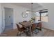 Modern dining area features a rustic wood table and leather chairs at 2513 N 90Th Ln, Phoenix, AZ 85037