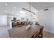 Spacious dining room with a long wooden table and leather chairs at 2513 N 90Th Ln, Phoenix, AZ 85037