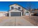 Two story home with gray garage door and landscaped yard at 2513 N 90Th Ln, Phoenix, AZ 85037