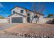 Two story home with gray garage door and landscaped yard at 2513 N 90Th Ln, Phoenix, AZ 85037