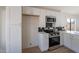 White kitchen cabinets and stainless steel appliances in this updated kitchen at 2513 N 90Th Ln, Phoenix, AZ 85037