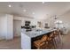 Modern kitchen with white cabinets, quartz countertops, and an island with seating at 2513 N 90Th Ln, Phoenix, AZ 85037