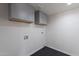 Laundry room with gray cabinets and patterned floor tile at 2513 N 90Th Ln, Phoenix, AZ 85037