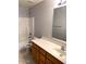 Bathroom with wood cabinets, single sink vanity and bathtub at 25527 W Burgess Ln, Buckeye, AZ 85326