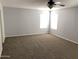 Bright bedroom featuring carpet, large windows, and ceiling fan at 25527 W Burgess Ln, Buckeye, AZ 85326