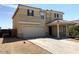 Two story house with tan exterior, two car garage, and covered entryway at 25527 W Burgess Ln, Buckeye, AZ 85326