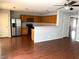 Kitchen with wood cabinets, stainless steel appliances, and hardwood floors at 25527 W Burgess Ln, Buckeye, AZ 85326