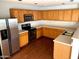 Kitchen with wood cabinets, stainless steel appliances, and hardwood floors at 25527 W Burgess Ln, Buckeye, AZ 85326