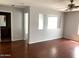 Living room with hardwood floors, neutral walls and a view into another room at 25527 W Burgess Ln, Buckeye, AZ 85326