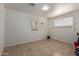 Simple bedroom with tile floors, a mirror, and window coverings at 2738 N 40Th Dr, Phoenix, AZ 85009