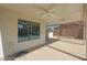 Covered patio with ceiling fan and window overlooking backyard at 277 E Windsor Ct, Gilbert, AZ 85296