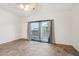 Living room with tile floors, sliding doors to a balcony, and neutral colors at 2950 W Louise Dr # 203, Phoenix, AZ 85027