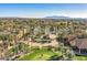 Aerial view of a community with golf course, club house, and palm trees at 3199 N 159Th Dr, Goodyear, AZ 85395