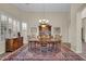 Formal dining room featuring a large table, wood chairs, and a beautiful area rug at 3199 N 159Th Dr, Goodyear, AZ 85395