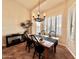 Bright dining room with wood table, chandelier, and plantation shutters at 3199 N 159Th Dr, Goodyear, AZ 85395