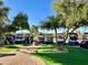 Row of golf carts parked under olive trees on a sunny day at 3199 N 159Th Dr, Goodyear, AZ 85395