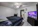 Main bedroom with large TV and ceiling fan at 3440 W Krall St, Phoenix, AZ 85017